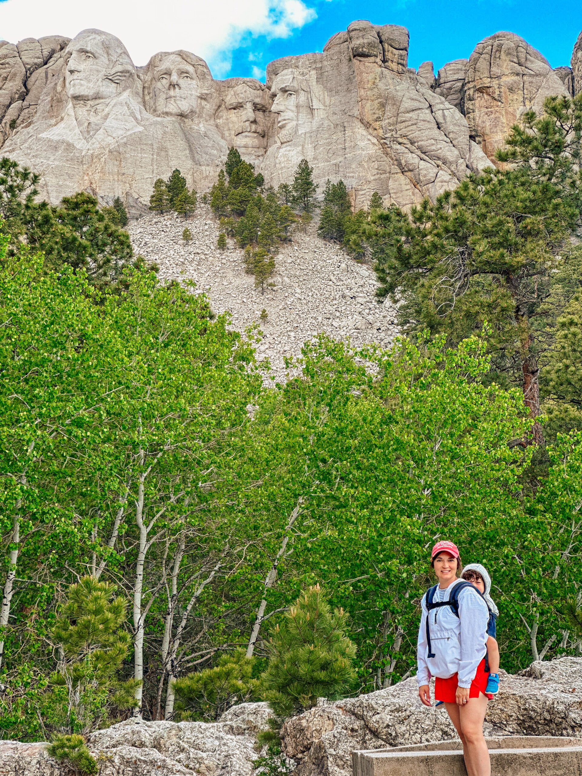 Mom standing in front of Mt. Rushmore with kids