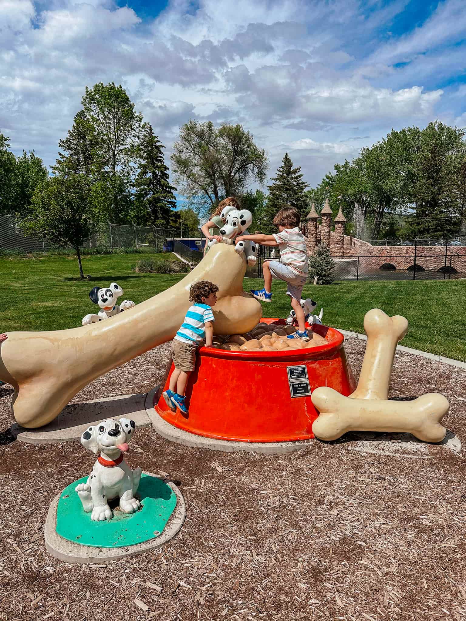 children climbing on 101 dalmation play structure at storybook island 