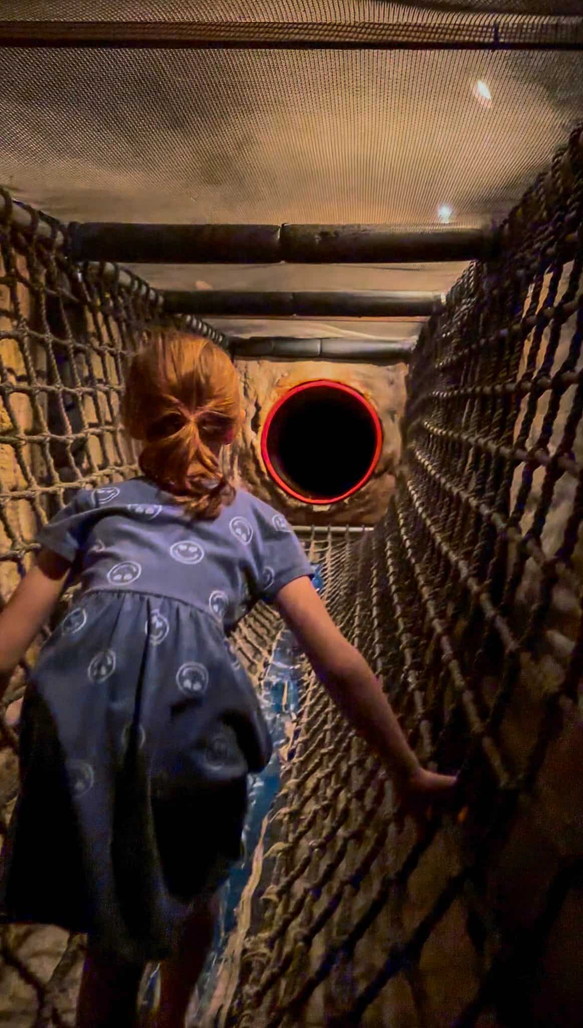 girl climbing through science center in hot springs