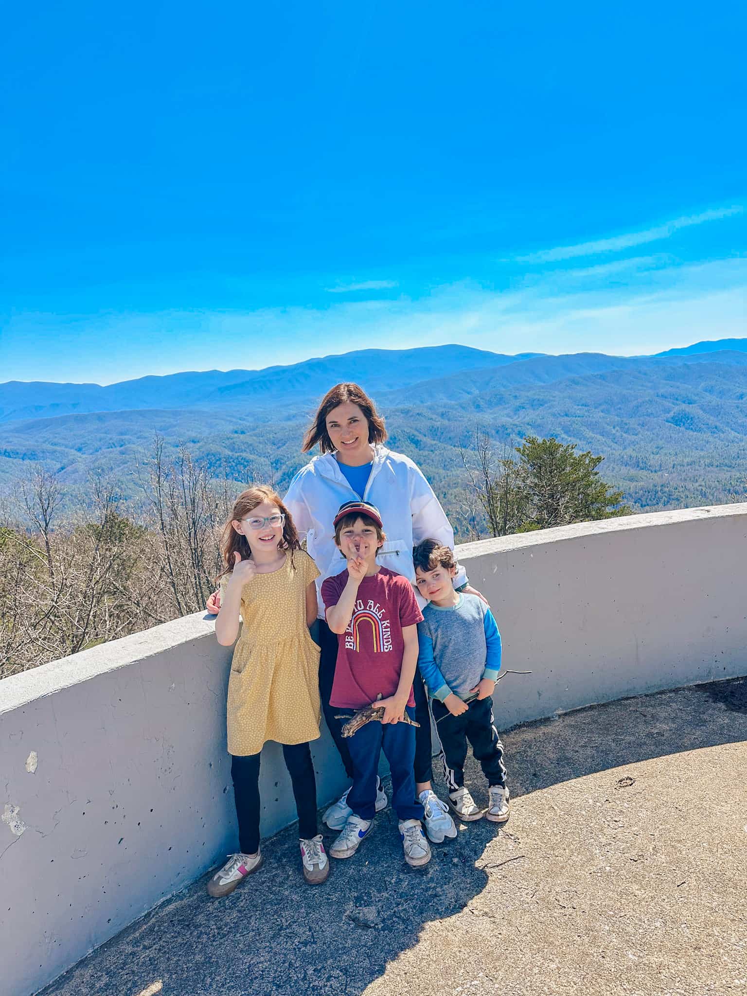 family posing in front of overlook at Look Rock in Smoky Mountains