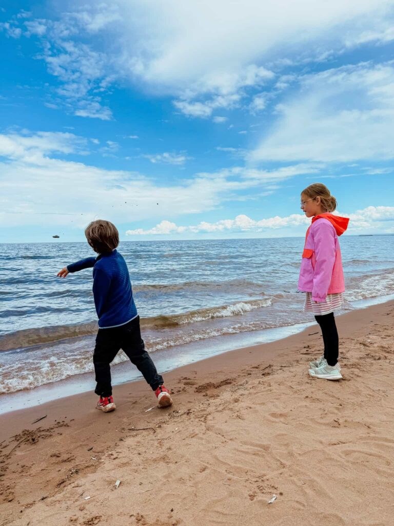 kids throwing rocks in lake superior in duluth minnesota