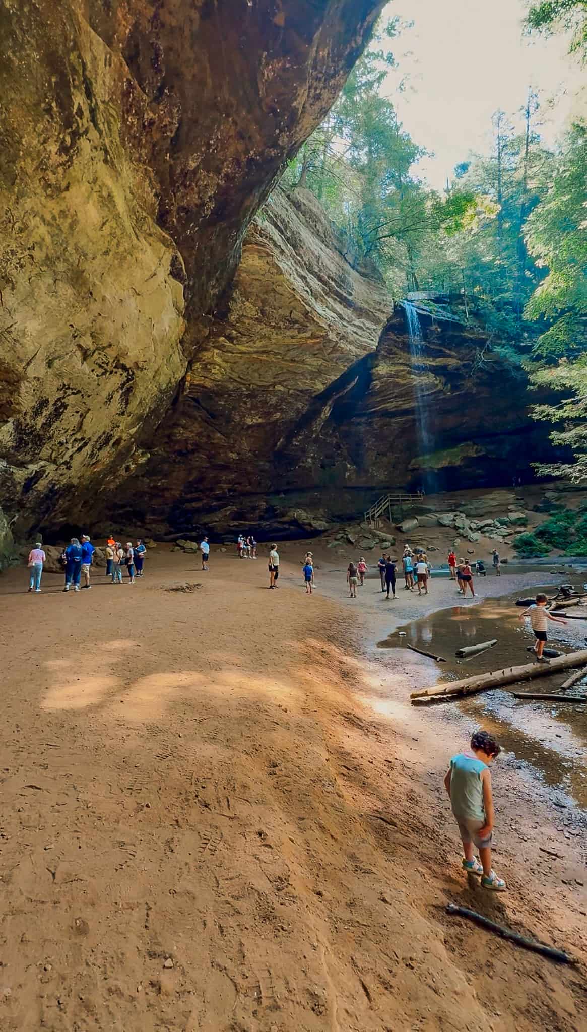 family exploring ash cave at hocking hills state park