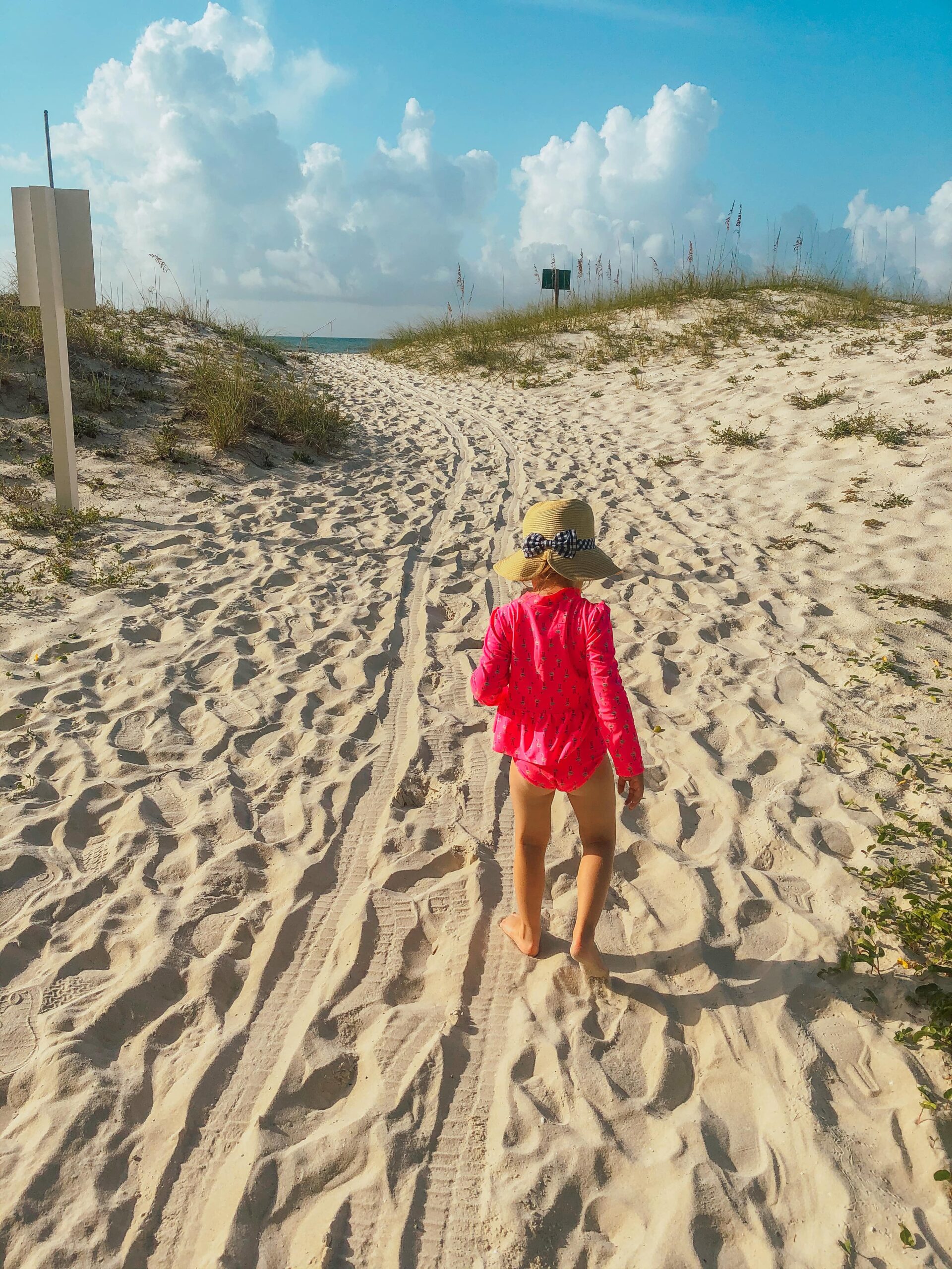Child walking across the sandy beaches in Gulf Shores