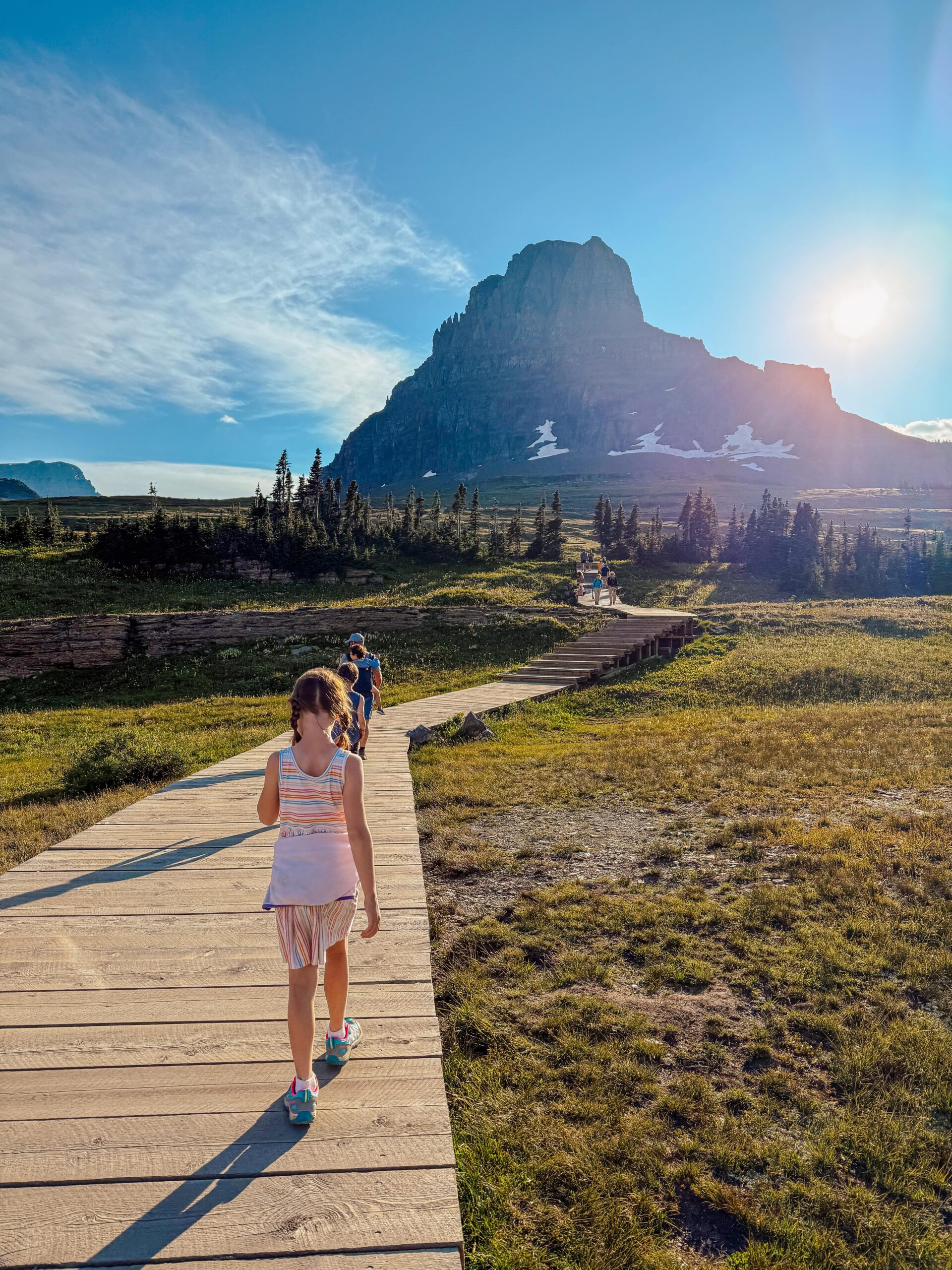 Family hiking to Hidden Pass Lake in Glacier National park.