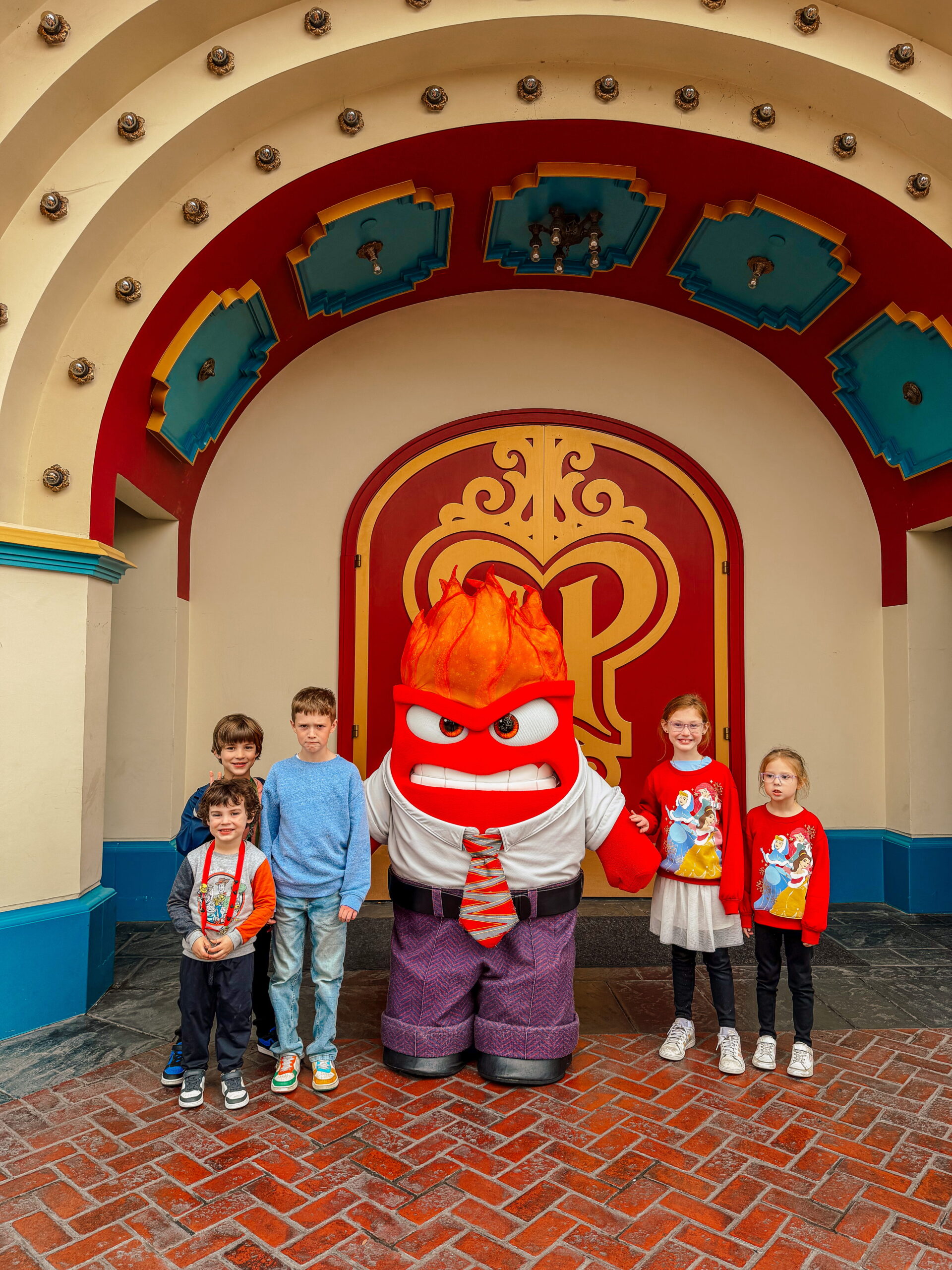 kids posing with Anger from Inside Out at Disneyland