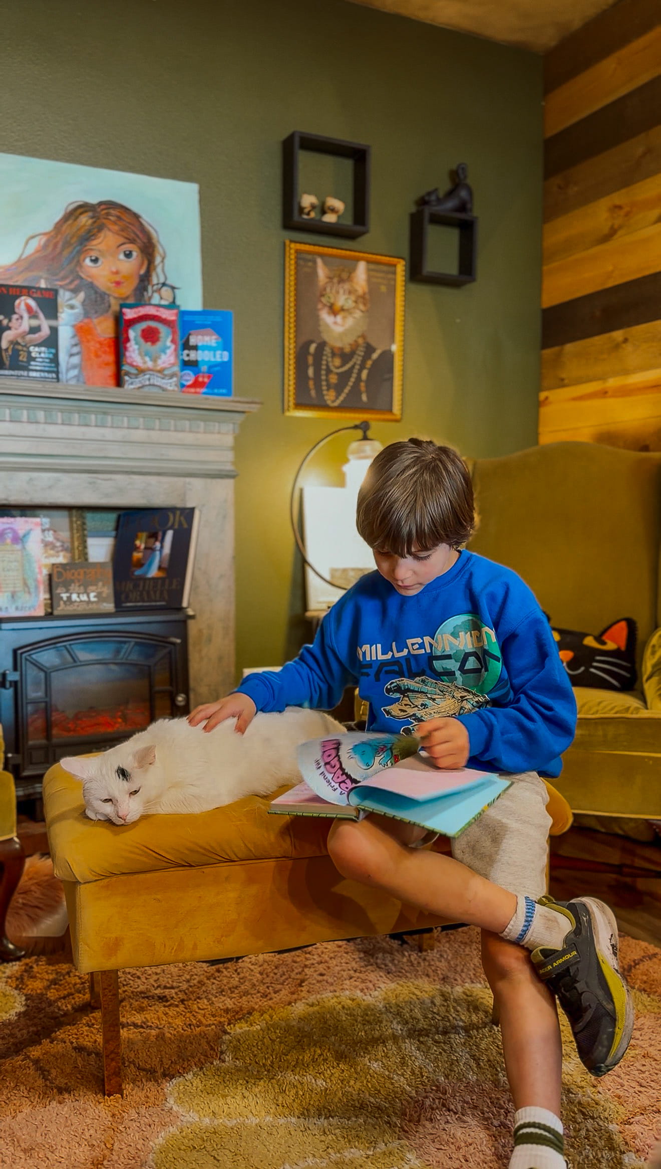 Boy reading to a cat at Literary Cat Co in Pittsburg Kansas