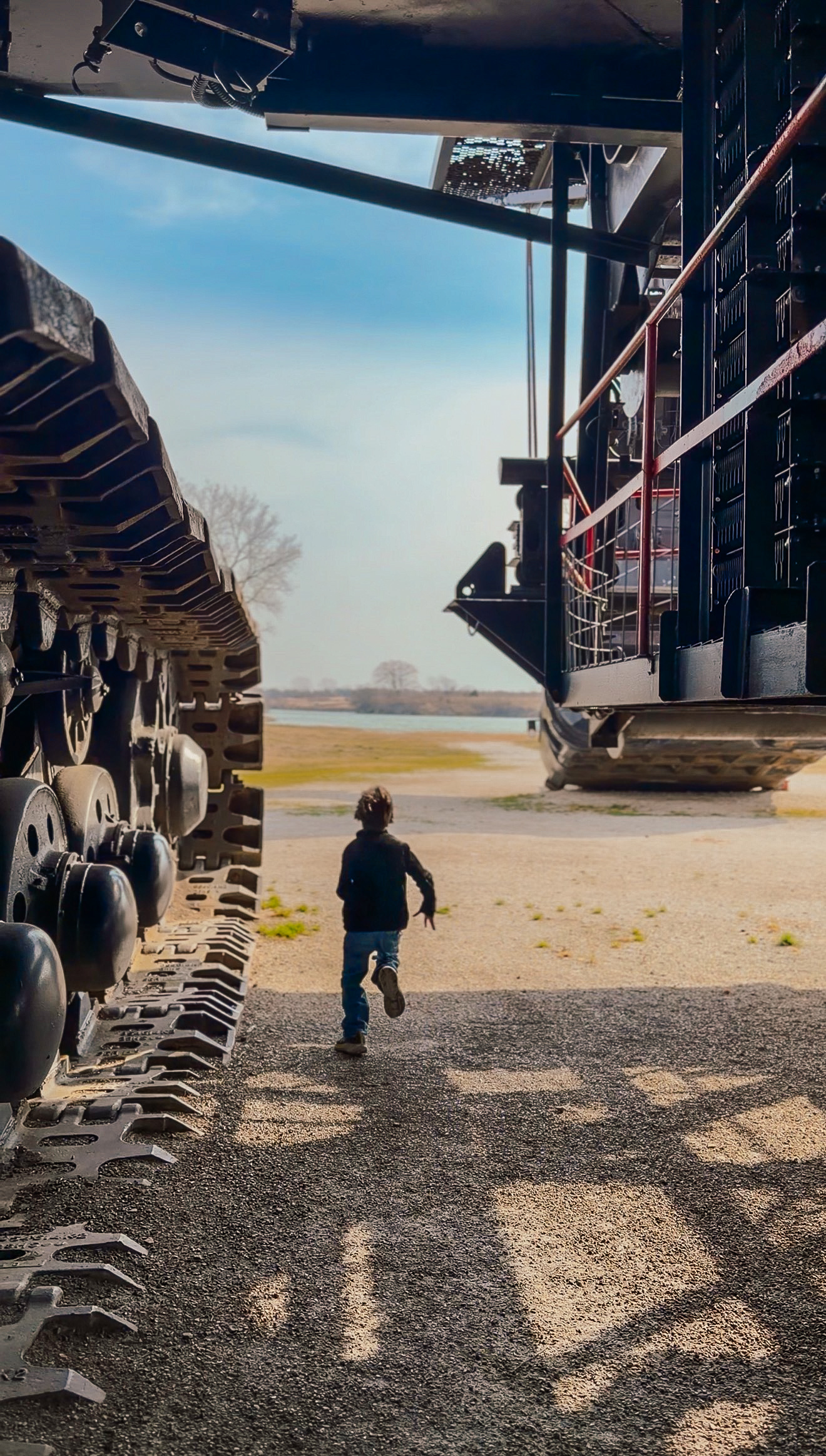 Boy running underneath Big Brutus in Kansas 