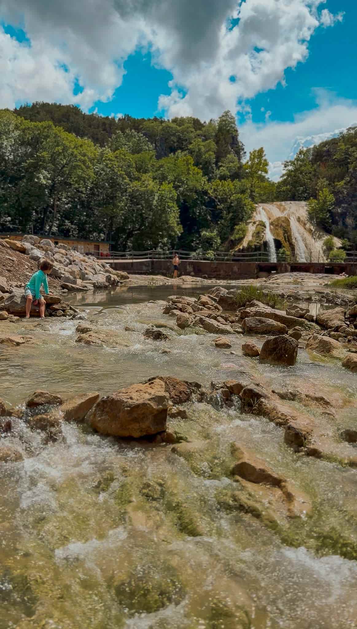 children playing in turner falls waterfall